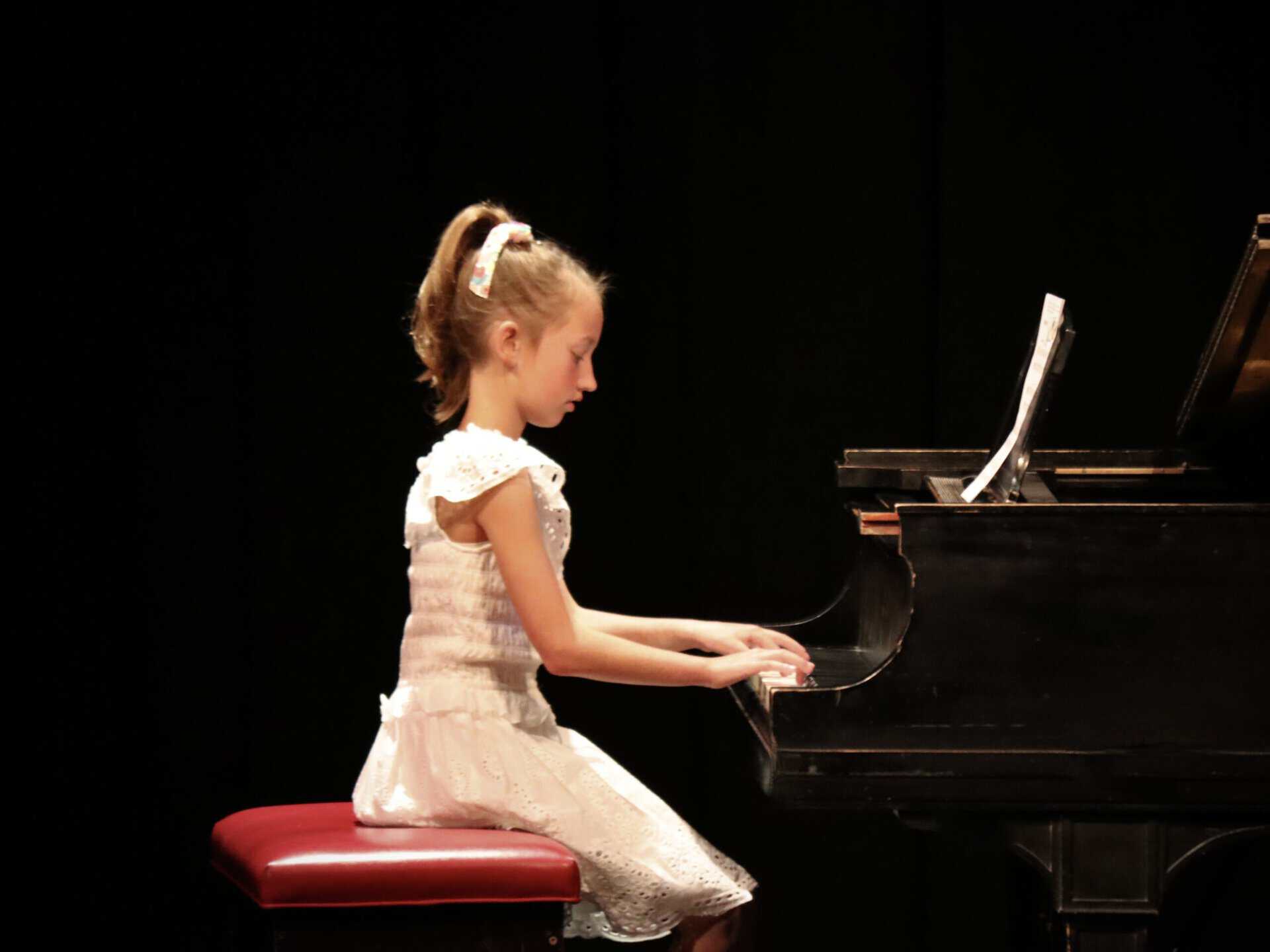Young Recital Pianist, sitting on the bench at the piano