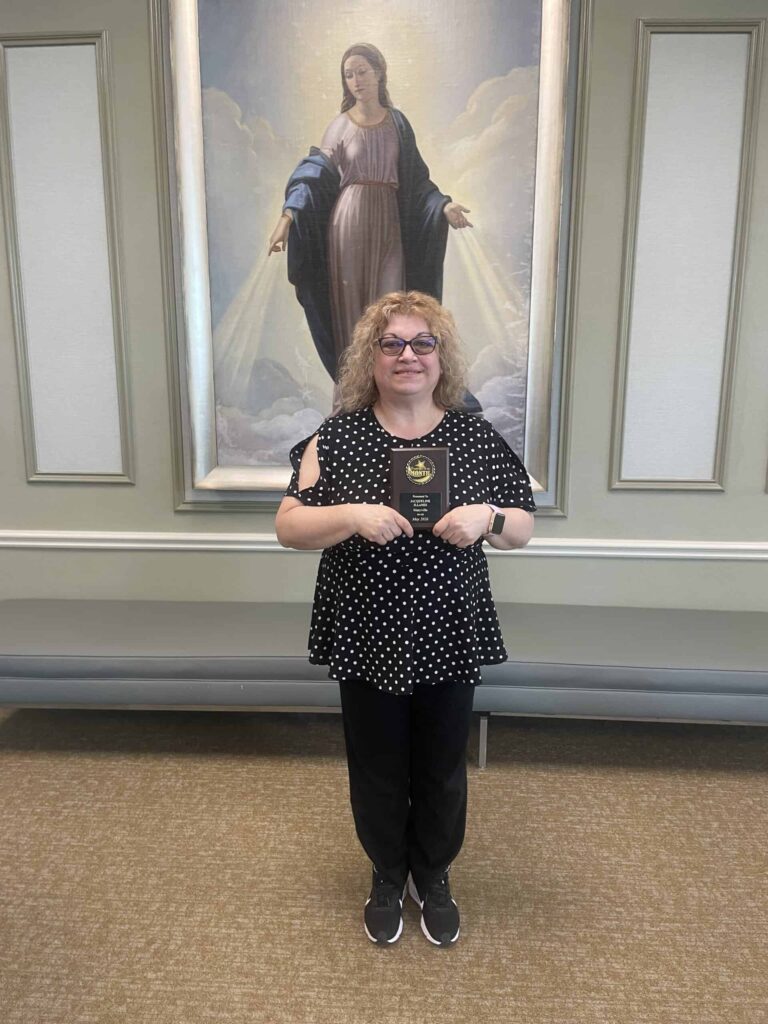 Jacqueline “Jackie” Illanes, holding her Employee of the Month plaque