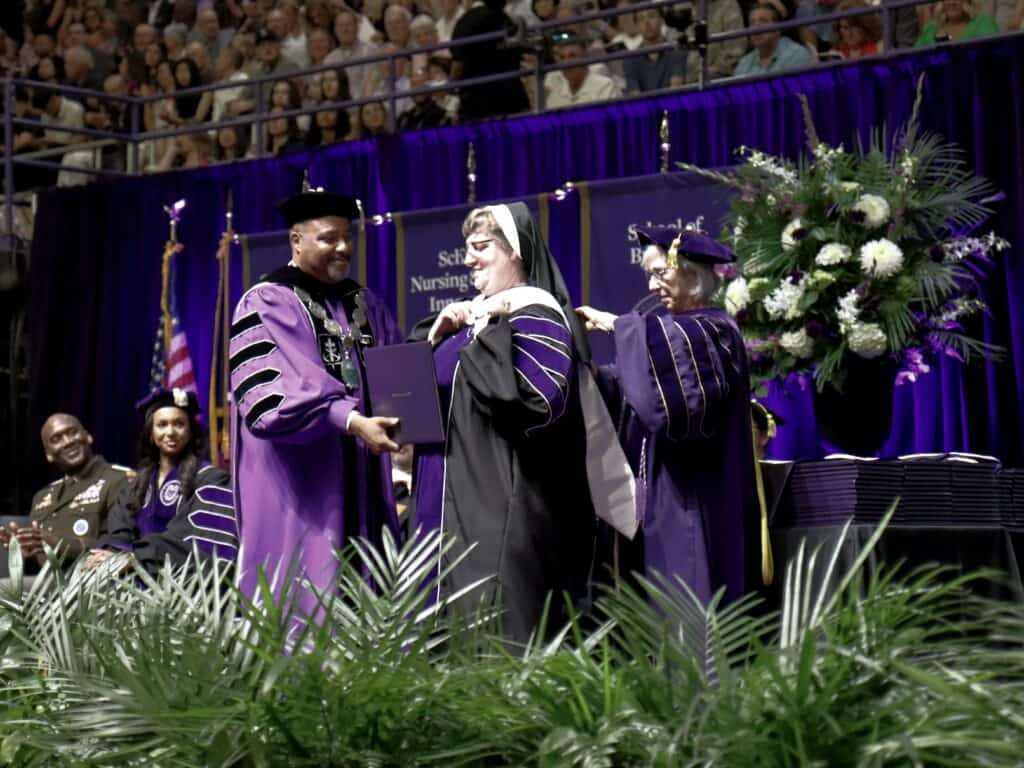 Sister receiving her doctorate at up graduation