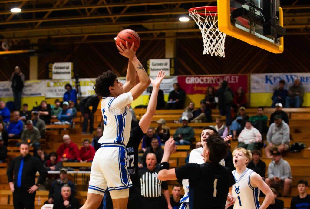 Boys Basketball Championship, VC player taking a shot against opponent