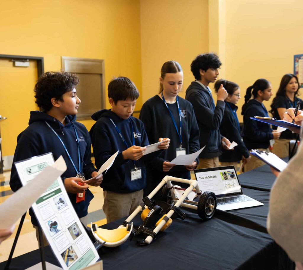 Students at table preparing for their Dog Mobility presentation