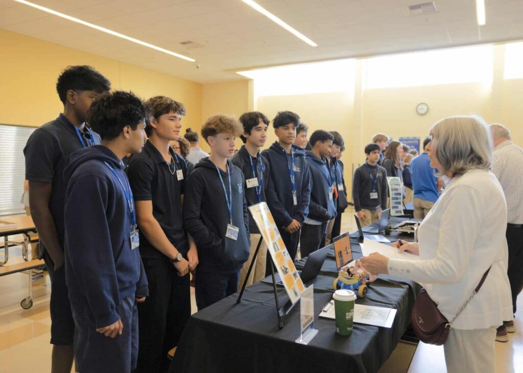 Panel of male students in conversation during their presentation
