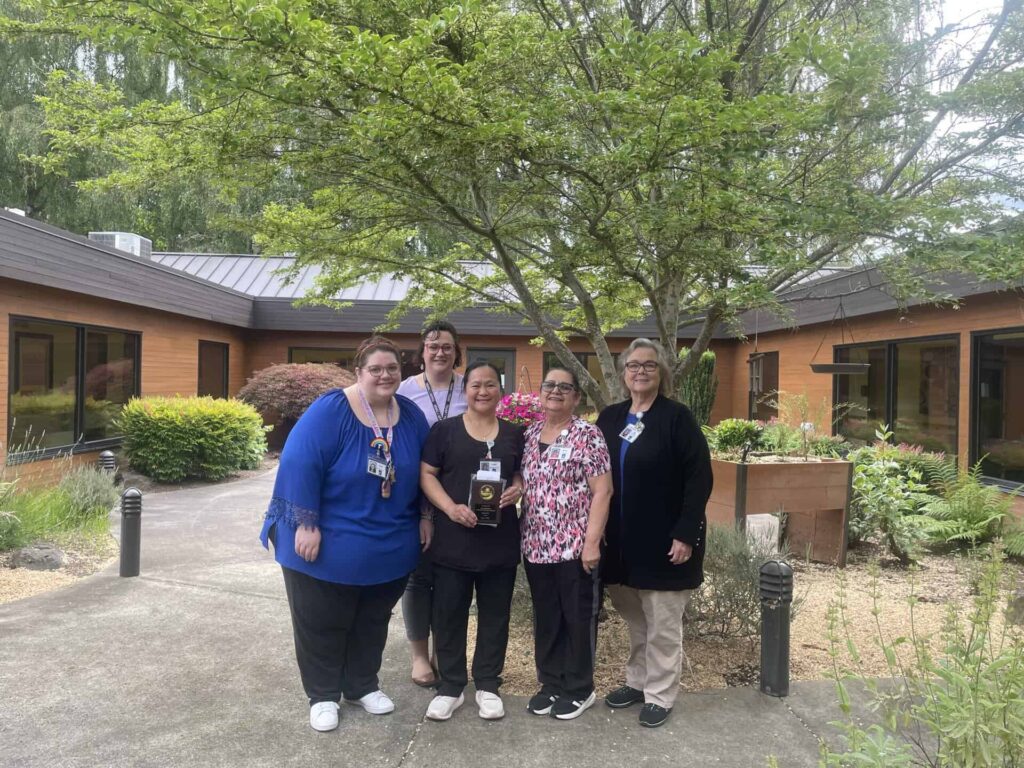 June 2026 Employee Of the Month, Ma Lopretti "Pretti" with her team