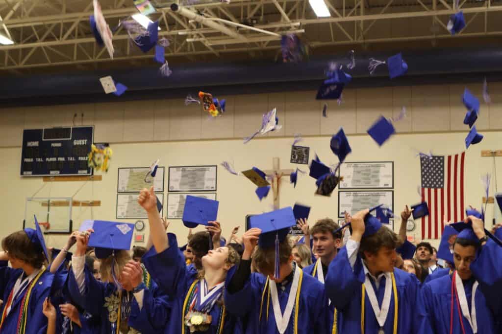 Graduates toss their caps