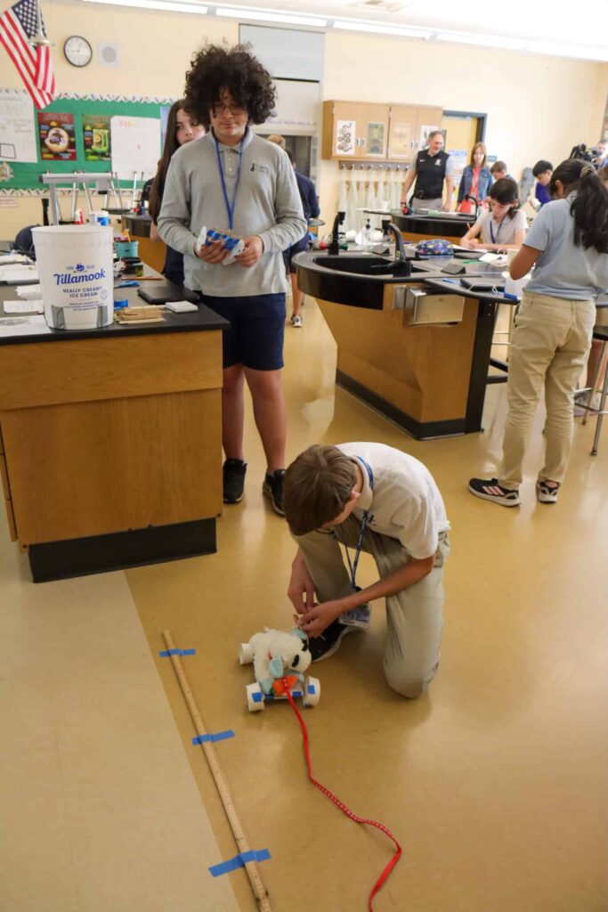 VCMS STEM Final, student is adding wheels to a stuffed animal