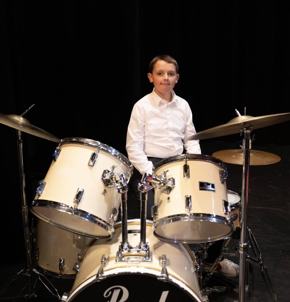 At the Young Artist Recital, a drummer with his drum set