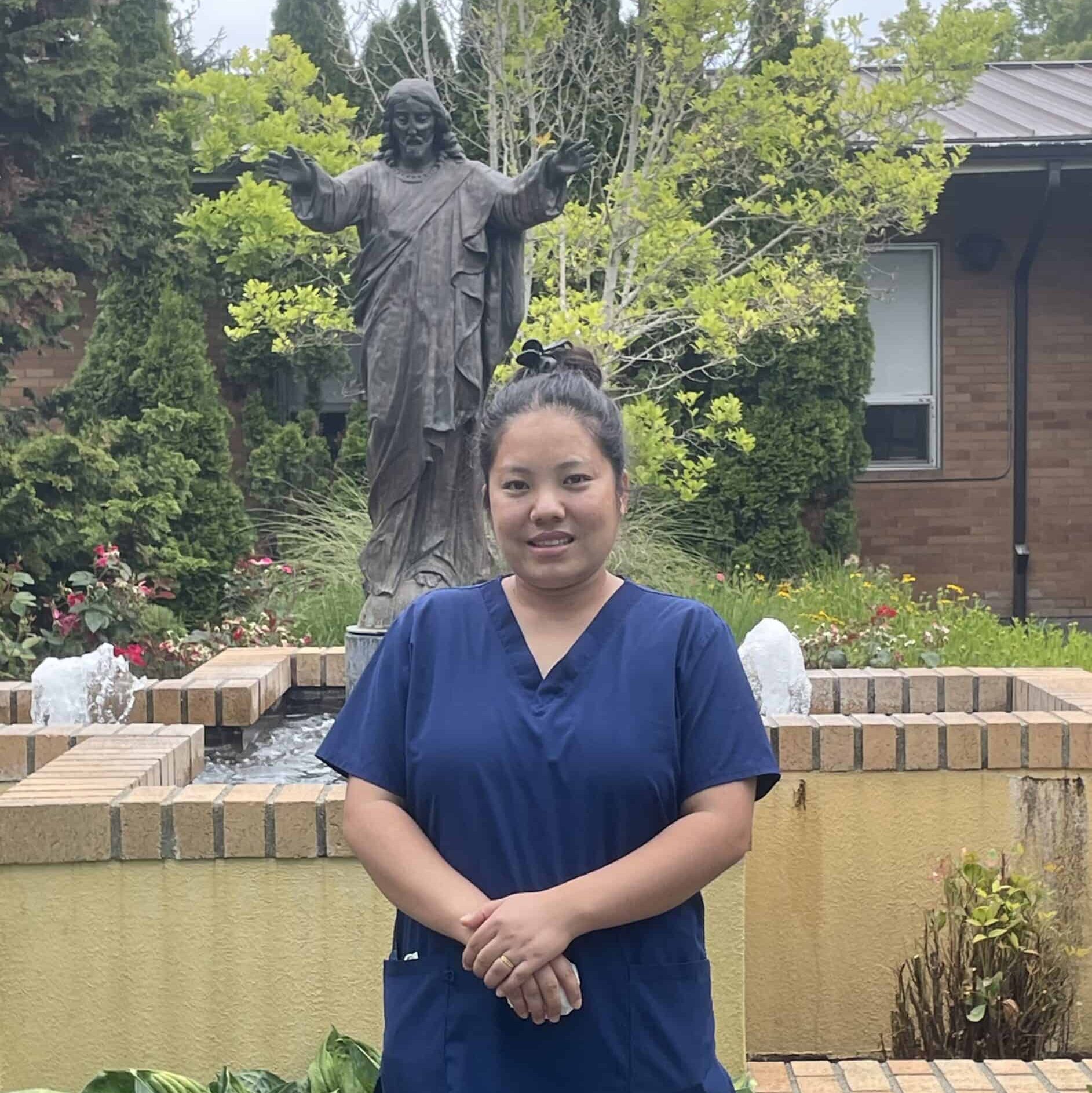 Pramila Gurung Amgain, Maryville’s Employee of the Month, standing in the garden