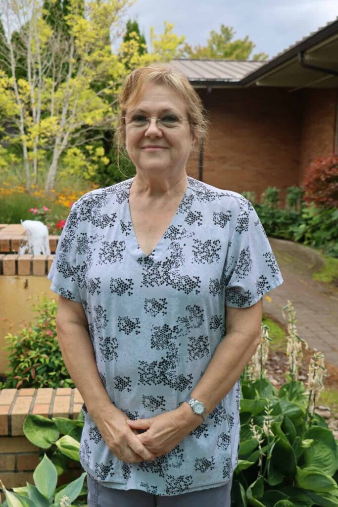 Sarah Kuni, RN - Maryville’s Employee of the Month for September. Posing in the garden.