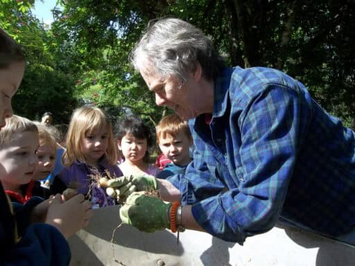 Sr. Marianne planting tulips with students