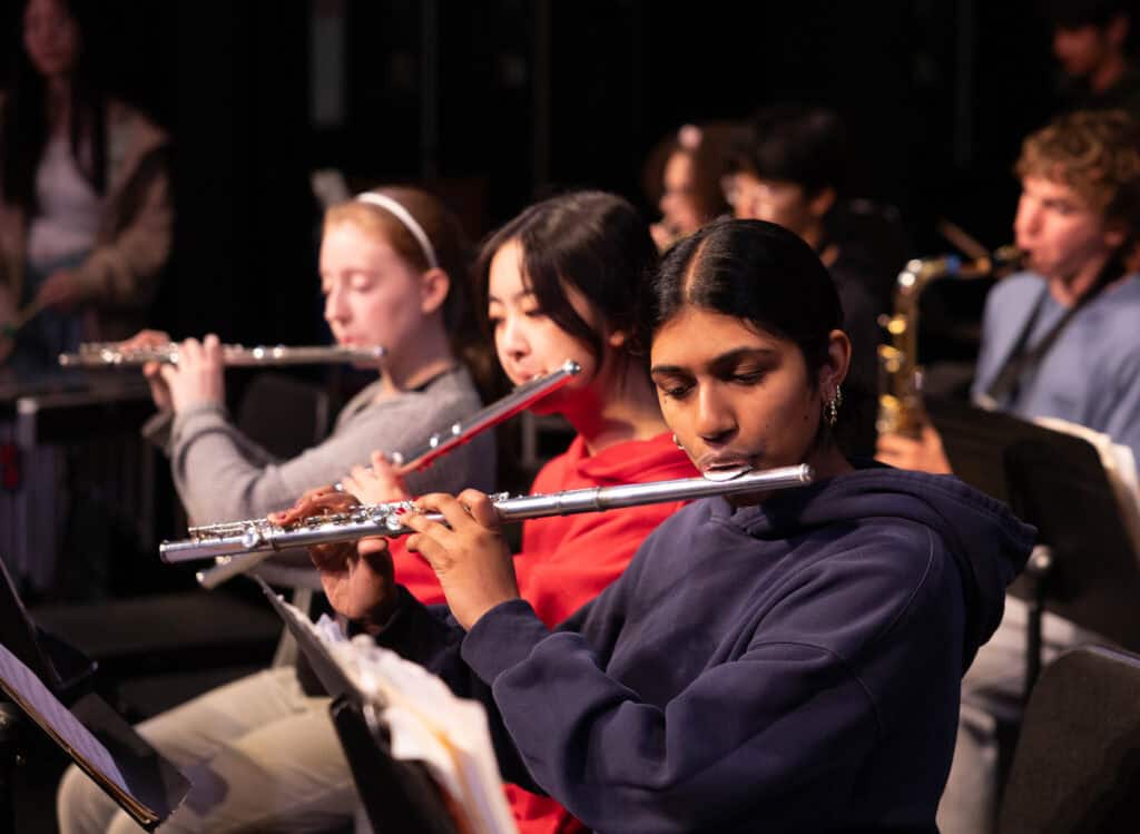 Students play flute at concert