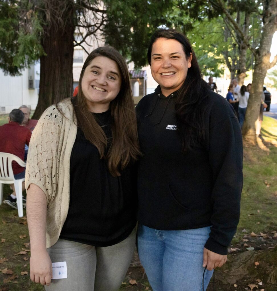 two alumni enjoying the tailgate festivities